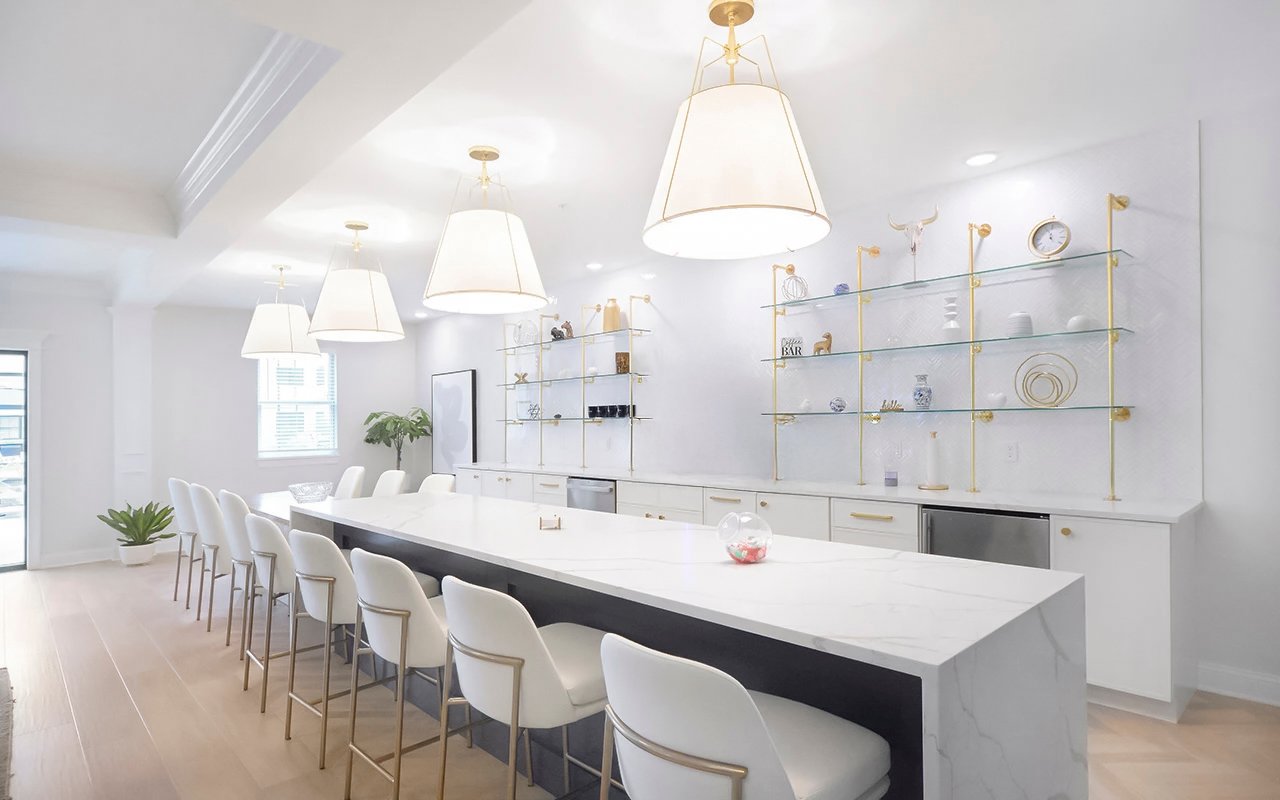 Image 1-RT Community kitchen and bar area with a long island, bar seating, and pendant lighting